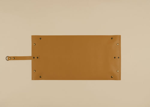 30x60cm in size, A yellow leather rectangular sleeve or pouch with a strap on the left side and brass-tone rivets, shown flat against a solid beige background.