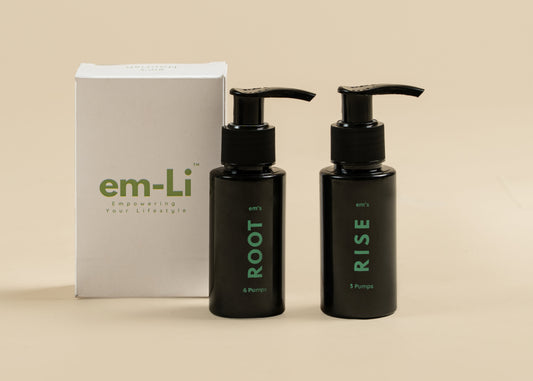 Two black pump bottles labeled ROOT and RISE with green text, standing in front of a white em-Li box on a beige background.